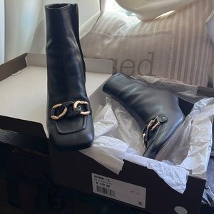 Black leather block heel boots.